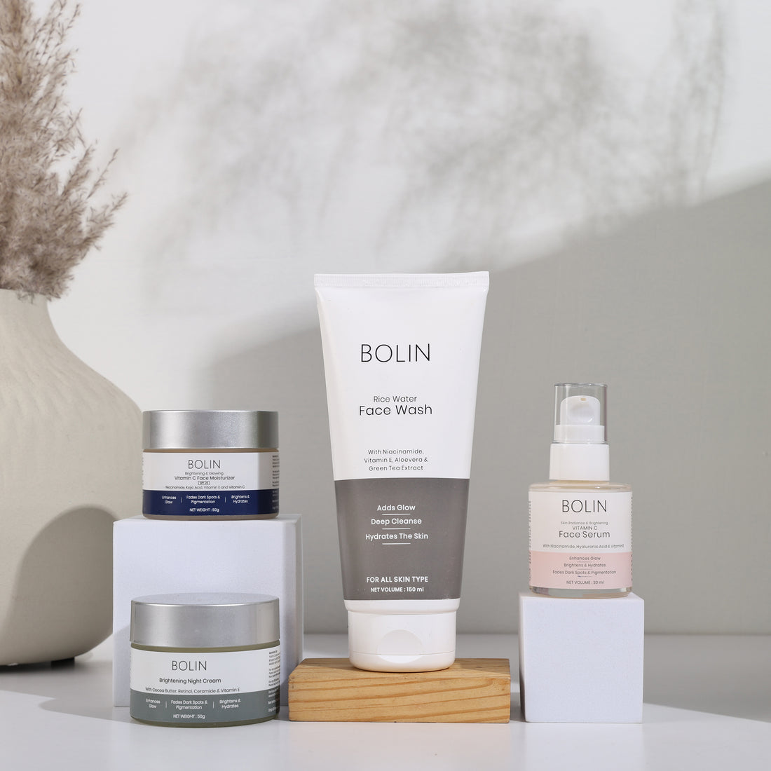 A collection of skincare products from BOLIN, including a face wash, face serum, and moisturizer.